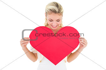 Attractive young blonde showing red heart