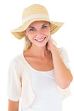 Attractive young blonde smiling at camera in sunhat