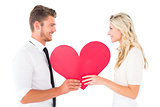 Attractive young couple holding red heart