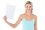 Happy blonde holding a sheet of paper