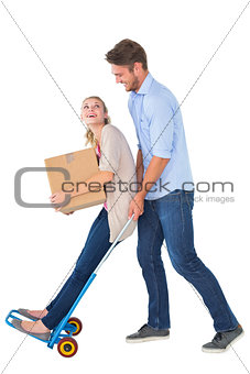 Young couple having fun on moving trolley