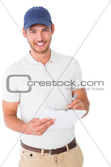 Happy delivery man holding clipboard