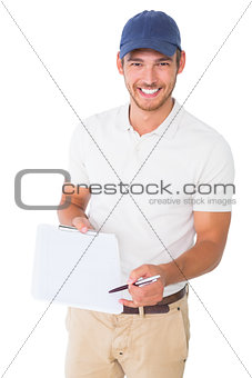 Happy delivery man holding clipboard