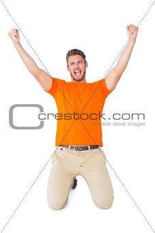 Excited man in orange cheering