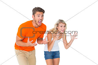 Excited football fan couple looking nervous