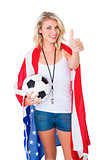 Pretty blonde football fan wearing usa flag showing thumbs up