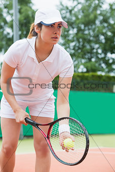 Focused tennis player ready to serve
