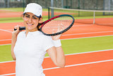 Pretty tennis player smiling at camera
