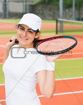Pretty tennis player smiling at camera