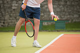 Young tennis player about to serve