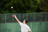 Young tennis player about to serve