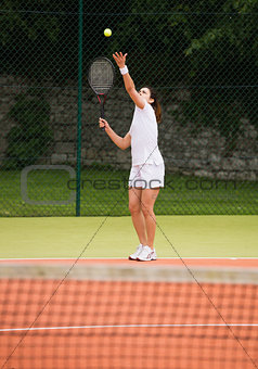 Pretty tennis player about to serve