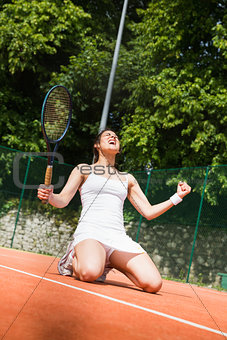 Pretty tennis player celebrating a win