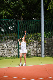 Pretty tennis player serving the ball