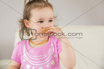 Close up of cute girl eating biscuit