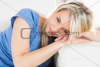 Relaxed woman lying on sofa in living room
