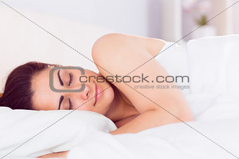 Relaxed beautiful woman sleeping in bed