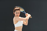 Portrait of confident female tennis player with racquet