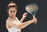 Portrait of confident female tennis player with racquet