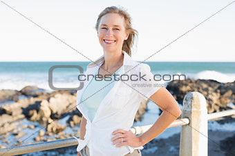Casual woman smiling by the sea
