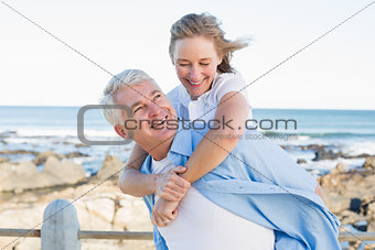 Casual couple having fun by the sea
