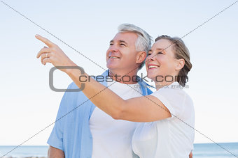 Happy casual couple looking at something