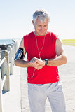 Fit mature man checking the time on the pier
