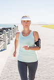 Fit mature woman jogging on the pier