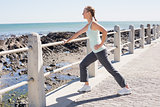 Fit mature woman warming up on the pier