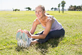 Fit mature woman warming up on the grass