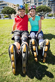 Fit mature couple wearing roller blades on the grass