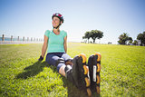 Fit mature woman in roller blades on the grass