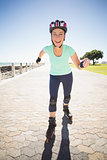 Fit mature woman rollerblading on the pier
