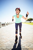 Fit mature woman rollerblading on the pier