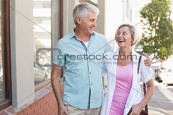 Happy mature couple walking in the city