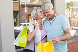 Happy mature couple looking at their shopping purchases