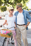 Happy mature couple going for a bike ride in the city