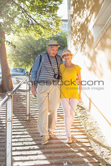 Happy tourist couple walking in the city