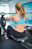 Woman working on fitness machine at gym