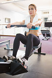Woman working on fitness machine at gym