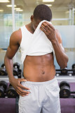 Fit man wiping sweat after workout
