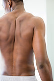 Rear view of a shirtless muscular man