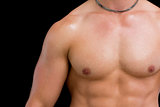 Close-up mid section of shirtless muscular man