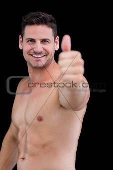 Shirtless muscular man giving thumbs up