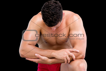 Close-up of a shirtless muscular man bending