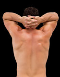 Rear view of a shirtless muscular man