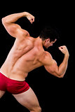 Rear view of a shirtless muscular man flexing muscles