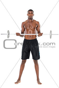 Portrait of a serious fit young man lifting barbell