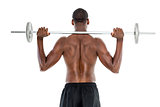 Rear view of a fit shirtless man lifting barbell