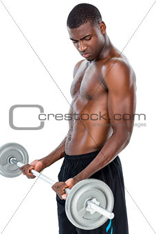 Determined fit shirtless man lifting barbell